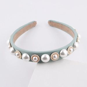 Detail of vintage thick light green milk silk headband with elegant pearls and gold trim