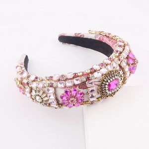 Ornate Baroque headband with colorful rhinestones and pearls on pink jacquard fabric