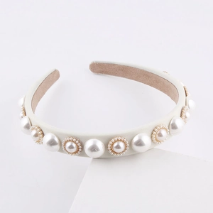 Elegant white fabric headband with vintage pearls and gold scalloped trim on white stand