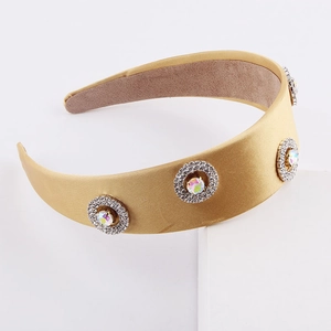 Detail of wide satin headband in champagne gold with sparkling rhinestone clusters