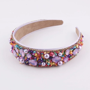 Detailed macro view of baroque headband with colorful rhinestones and purple pearls