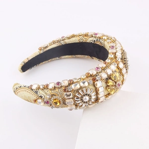 Detail of baroque headband with gold jacquard fabric, crystals, and faux pearls