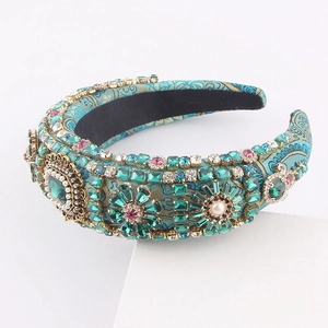 Luxury Baroque style headband with emerald green rhinestones and pearls on blue silk fabric