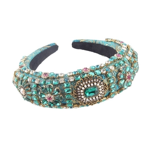 Baroque style padded headband with emerald green crystals and vintage gold floral details