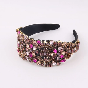 Detailed close-up of colorful baroque rhinestones hand-set on a wide black velvet headband
