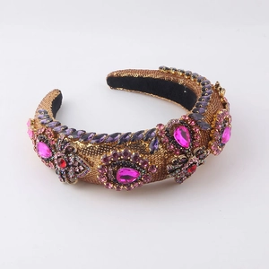 Detailed macro of Baroque sponge headband with pink rhinestones and gold sequins fabric