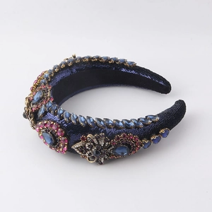 Detailed macro view of baroque padded headband with sequins and colorful gemstones