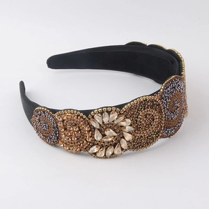 Baroque style padded headband featuring elaborate rhinestone beadwork on black satin