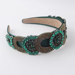 Vintage Baroque green velvet headband with floral crystal geometric design shown in 45-degree angle
