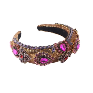 Baroque padded headband with gold sequins and purple crystals on a white background