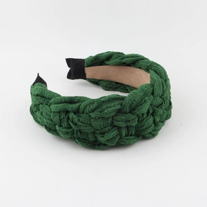 Detailed view of forest green woven fabric headband with thick braided texture