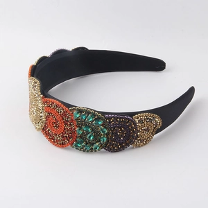 Close-up of baroque headband with colorful rhinestone spirals and luxury beads