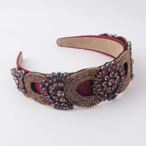 Detailed view of luxury baroque headband with purple crystals and red satin fabric