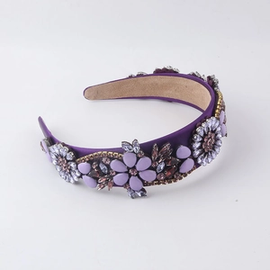 Detailed macro view of purple baroque headband with rhinestones and floral crystal patterns