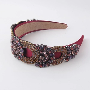Detail of burgundy satin headband with purple and colorful rhinestones in flower patterns