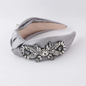 Detailed view of luxury grey silk headband with baroque crystal and rhinestone embellishment