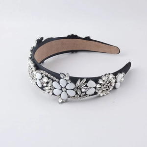 Detailed macro view of baroque headband with white floral petals and sparkling crystals
