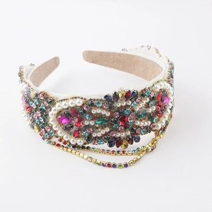 Close-up of luxury headband featuring colorful rhinestones, pearls, and fringe details