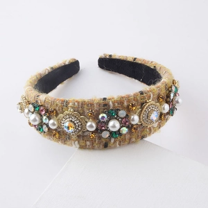 Detail of yellow tweed headband featuring pearls and colorful crystal floral embroidery