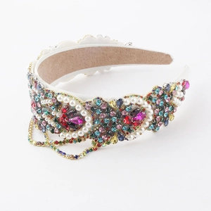 Close-up of wide headband featuring colorful rhinestones, pearls, and tassel chain