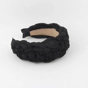 Detail of black woven texture headband with a soft khaki non-slip velvet lining