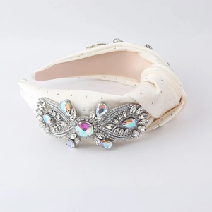 Detail of cream fabric headband with sparkling aurora crystals and rhinestone embellishments