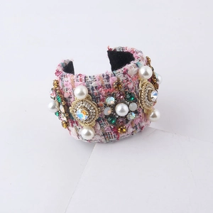 Detailed macro view of pink tweed open bangle with inlaid pearls and colorful rhinestones