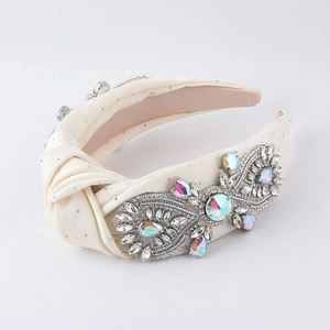 Detail of cream silk knotted headband with luxury crystal rhinestones in butterfly pattern