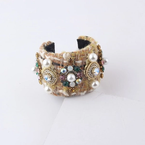 Detail view of tweed bangle bracelet with pearls and colorful crystal embellishments