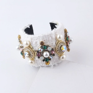 Detailed shot of white tweed cuff bracelet with faux pearls and colorful crystals