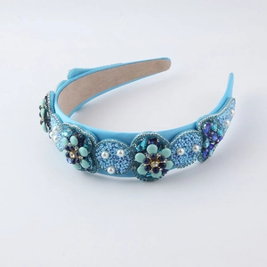 Close-up of blue baroque headband with intricate hand-stitched crystal flowers and pearls