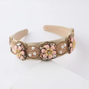 Champagne baroque floral headband with crystals and pearls on white stone display base