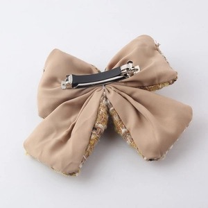 Chic tweed bow hair clip for women with yellow and white patterns on a metal spring clip