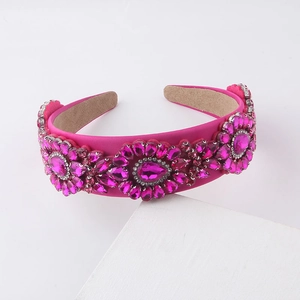 Close-up of bright rose velvet headband with shiny pink rhinestones in flower patterns