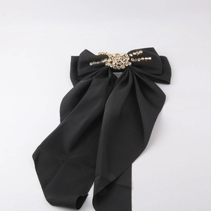 Fashionable black satin bow hair clip featuring sparkling rhinestones and gold base