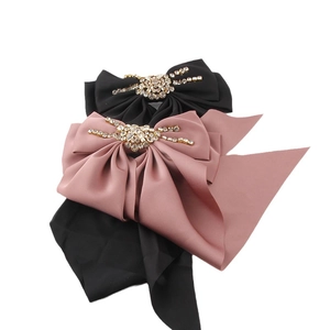 Elegant satin bow hair clips with rhinestone spider center in black and dusty rose