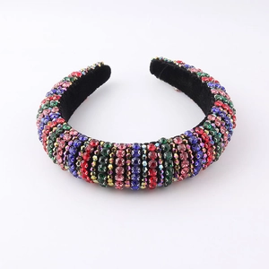 Close-up detail of Baroque sponge headband featuring colorful rhinestones on black velvet
