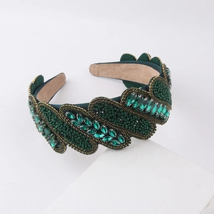 Detail of emerald green velvet headband with baroque rhinestone and beaded texture