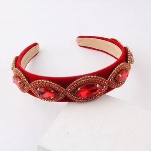 Macro shot of red velvet headband featuring large marquise gems and sparkling rhinestones