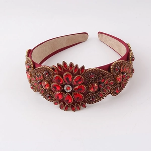 Macro detail of Baroque headband featuring red floral rhinestones and velvet lining