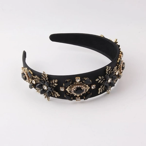 Baroque style wide headband with gold floral metal patterns and black faceted rhinestones