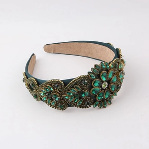 Detailed macro view of emerald green rhinestone baroque headband with suede lining