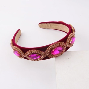 Close-up of baroque velvet headband with pink gemstones and sparkling crystal rhinestones