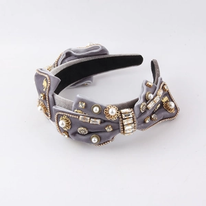 Detailed macro view of gray velvet headband with luxury pearls and rhinestone crystals