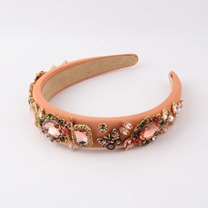 Detail of luxury peach padded headband with rhinestones and vintage butterfly ornaments