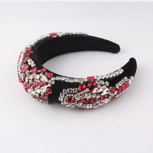 Detailed macro view of the black velvet headband featuring red and white rhinestones