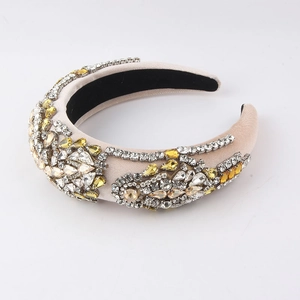 Detail of baroque rhinestone headband with crystal embellishments on beige satin fabric