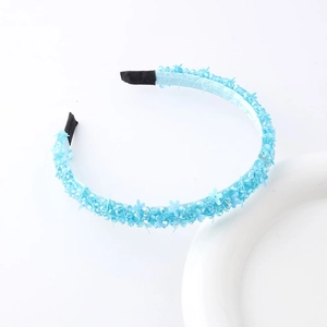 Detailed close-up of light blue beaded floral headband with intricate petal embellishments