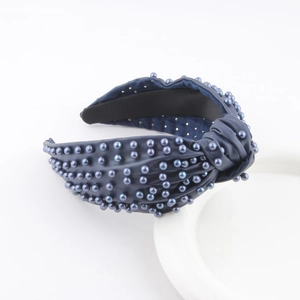 Navy blue faux leather headband with knotted detail and matching pearl embellishments