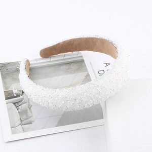 Close-up of luxury padded headband featuring intricate pearl and rhinestone beadwork